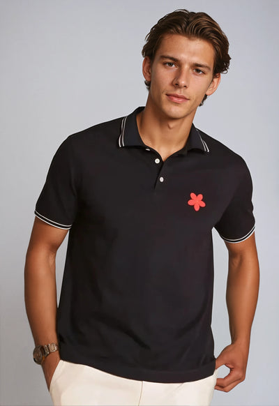 Made in Thailand, this Buki "happy" polo shirt features a "happy" flower motif on the chest. In Navy.