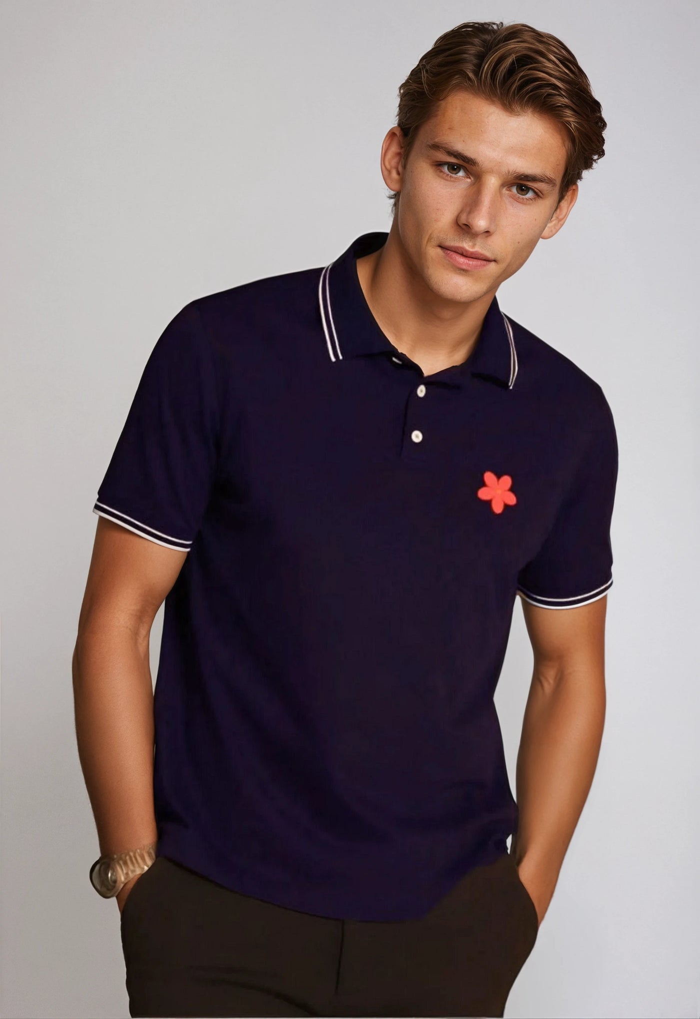 Made in Thailand, this Buki "happy" polo shirt features a "happy" flower motif on the chest. In Navy.