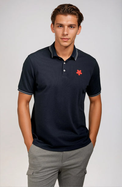 Made in Thailand, this Buki "happy" polo shirt features a "happy" flower motif on the chest. In Navy.